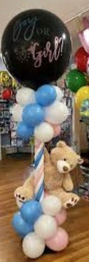 Baby gender reveal column in blue, pink and white.  Black balloon on top says Boy or Girl filled with confetti and small balloons will pop to reveal gender when poked with pin.