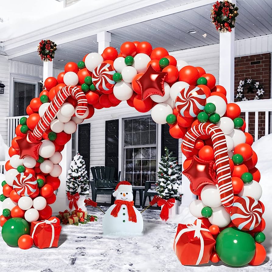 Balloon arch with candy canes, peppermint candy, and gifts.  Balloon arch is outside in front of a house