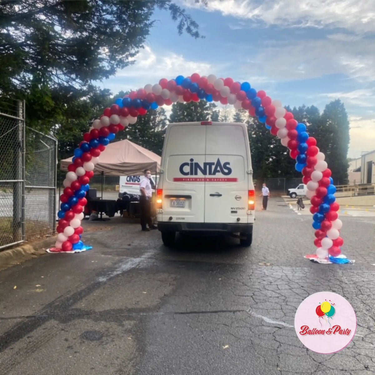 A festive archway made of red, white, and blue balloons.