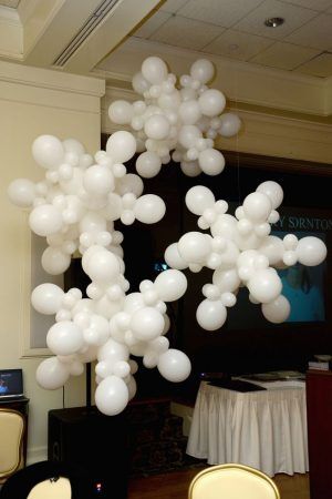 4 balloon snowflakes hanging from the ceiling