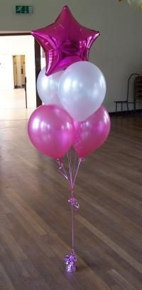 helium balloon bouquet of 4 latex party balloons and a star balloon creating a floor bouquet balloon bunch weighted with a foil balloon weight white and fuchsia balloons