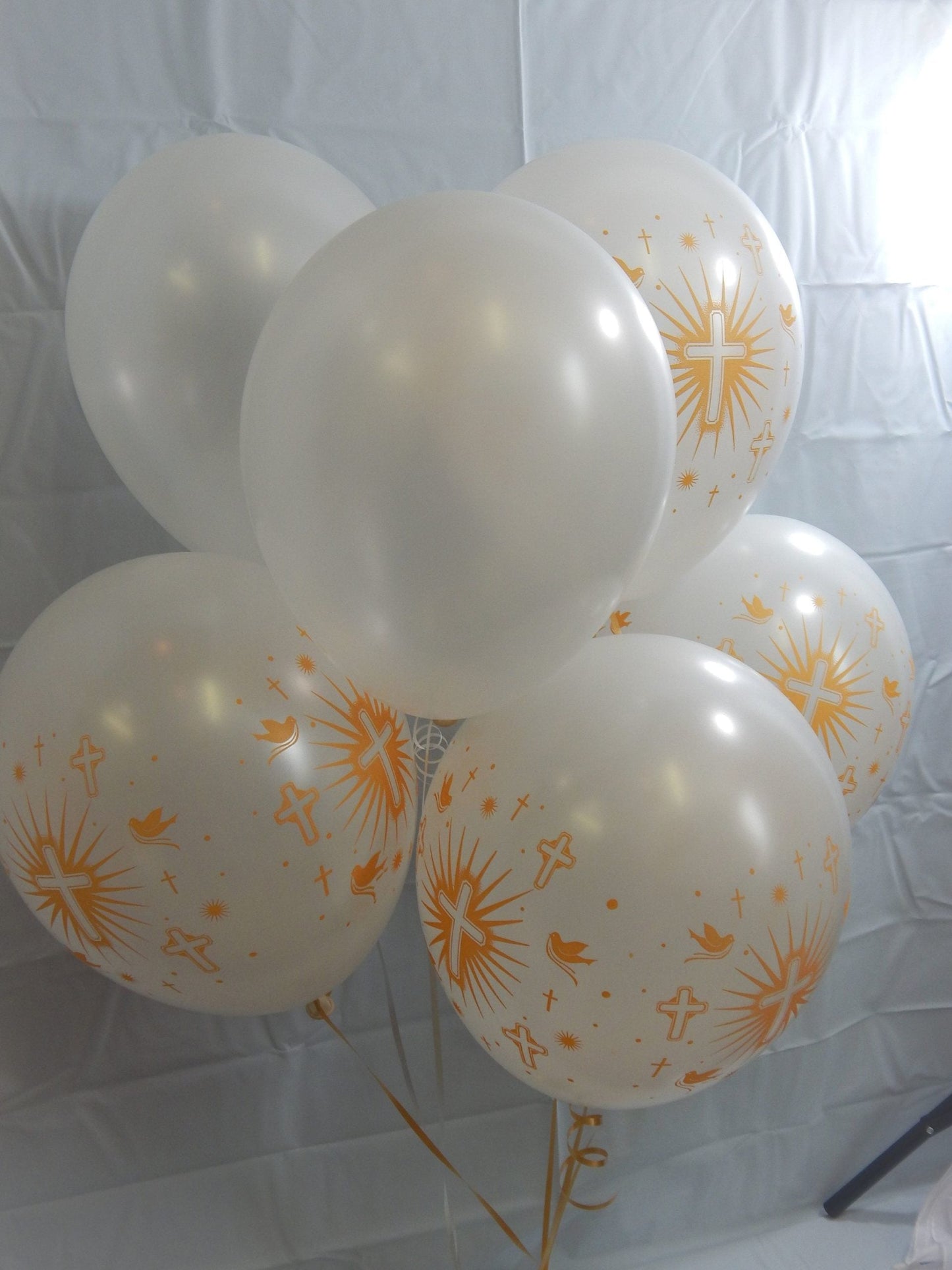 helium filled white balloons with gold cross and doves printed in gold