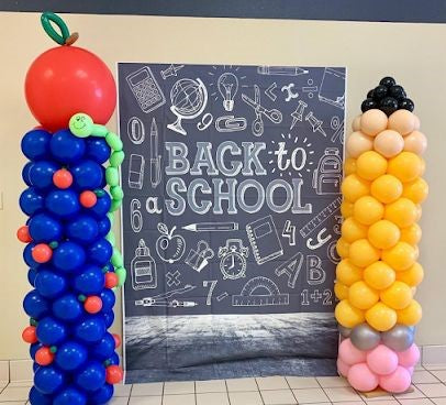 Blue balloon column with apple balloon on top and yellow pencil sculptured balloon column.  Back to school and graduation balloon decorations i