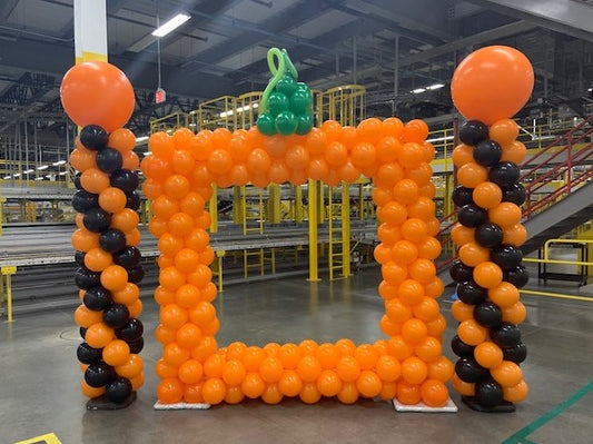 Halloween pumpkin themed balloon picture frame, balloon columns orange and black in Amazon fulfillment