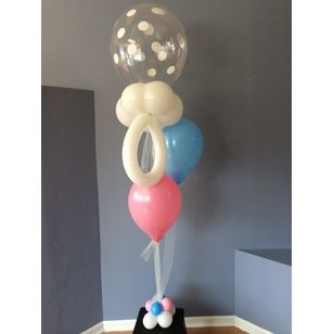helium balloon centerpiece with blue and pink balloons and a pacifier balloon on a weight of pink, blue and white balloons