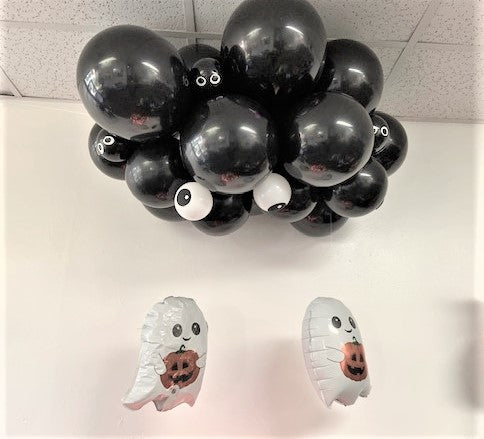 halloween black balloon cloud with ghost and spooky eyes 