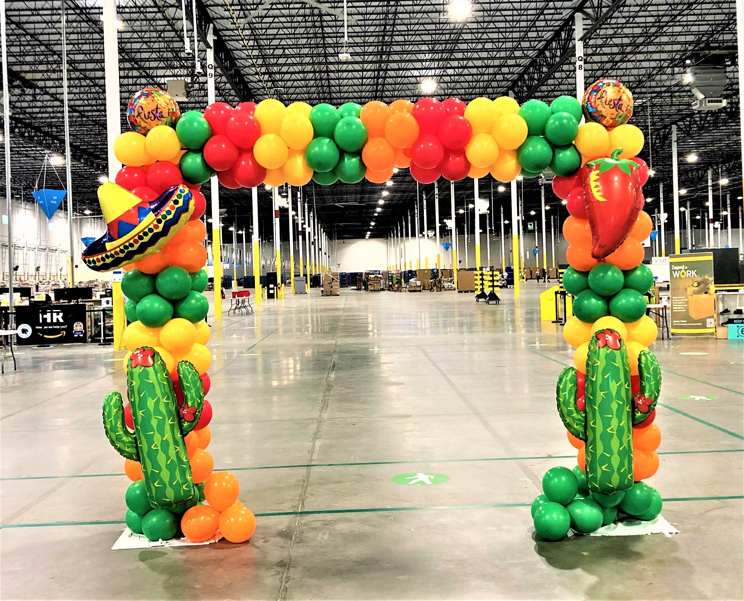 Cinco de Mayo balloon arch with sombrero balloons  chlli pepper  balloons cactus and fiesta balloons.  green red, yellow and orange balloons at Amazon warehouse  charlotte nc